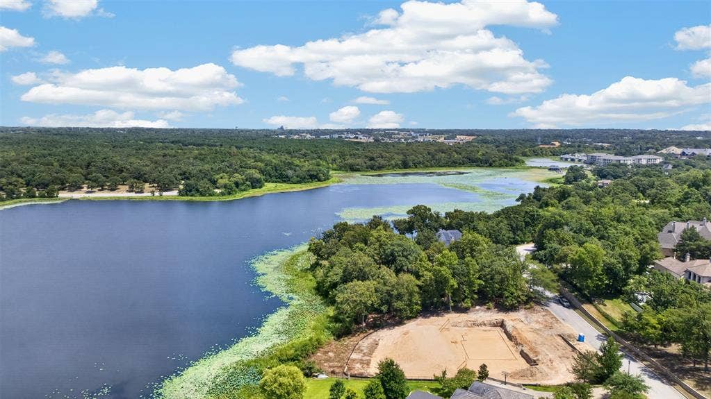4513 Cascades Shoreline Drive, Tyler, TX 75709 Expansive waterfront property featuring mature trees, a paved road, and a substantial body of water