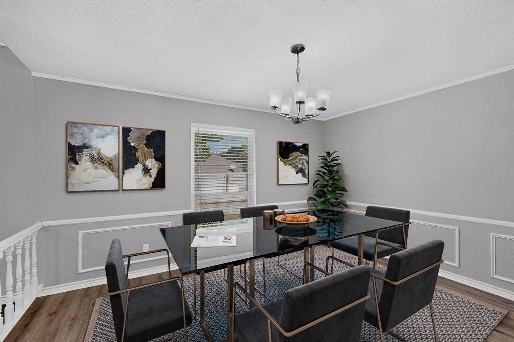Recessed window with blinds, decorative wainscoting, wood-finish flooring, and a multi-light chandelier