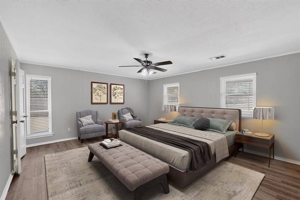 Wood-finish flooring, light gray wall tones, and white trim throughout