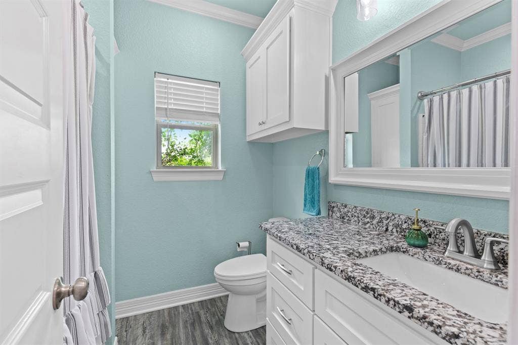 22477 County Road 2166, Troup, TX 75789 White shaker-style vanity with a granite countertop, undermount sink, and brushed nickel faucet