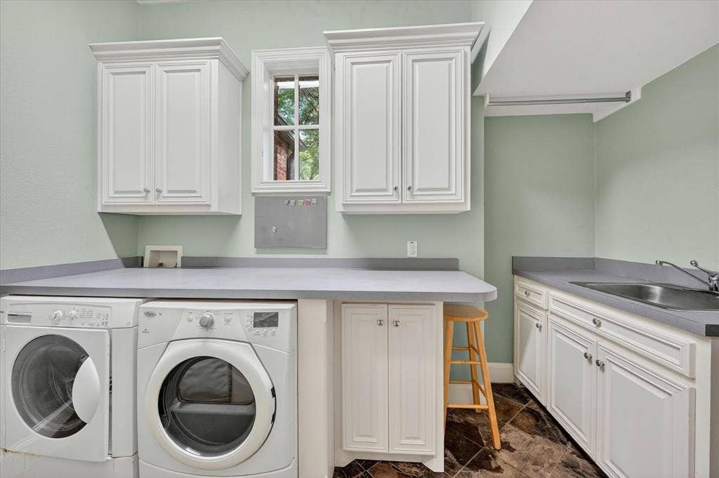 731 Creekwood Drive N, Fairview, TX 75069 Laundry room with built-in cabinets, sink, and counters for folding.