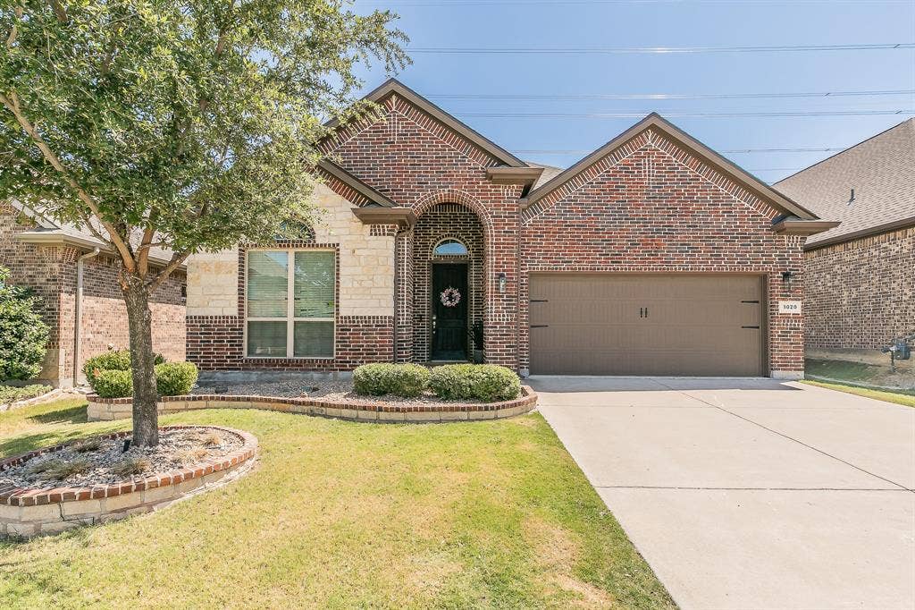 3020 Bella Lago Drive, Fort Worth, TX 76177 Brick and stone veneer exterior with an arched entry