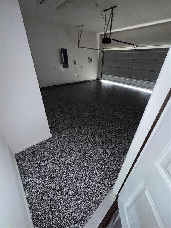 3020 Bella Lago Drive, Fort Worth, TX 76177 Garage with speckled epoxy flooring, white painted walls, and an automatic garage door opener