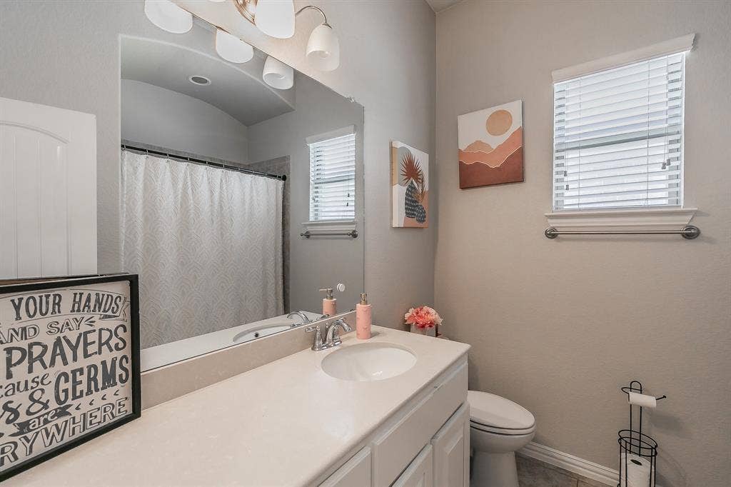 3020 Bella Lago Drive, Fort Worth, TX 76177 Single vanity with integrated sink, white cabinetry, and a full-width mirror