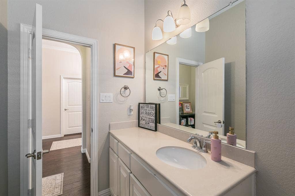 3020 Bella Lago Drive, Fort Worth, TX 76177 Single vanity with light-toned countertop, integrated sink, and chrome faucet in between the two bedrooms