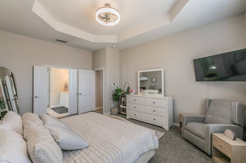 3020 Bella Lago Drive, Fort Worth, TX 76177 Tray ceiling with recessed lighting, neutral wall tones, and carpet flooring