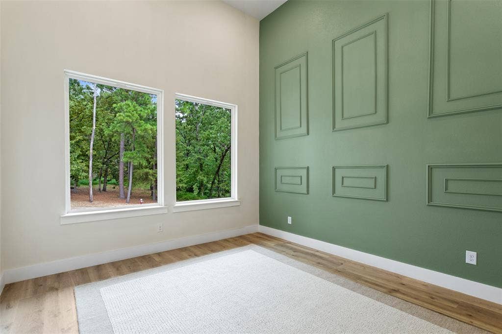 High ceilings enhance the spacious interior, complemented by two large windows offering abundant natural light