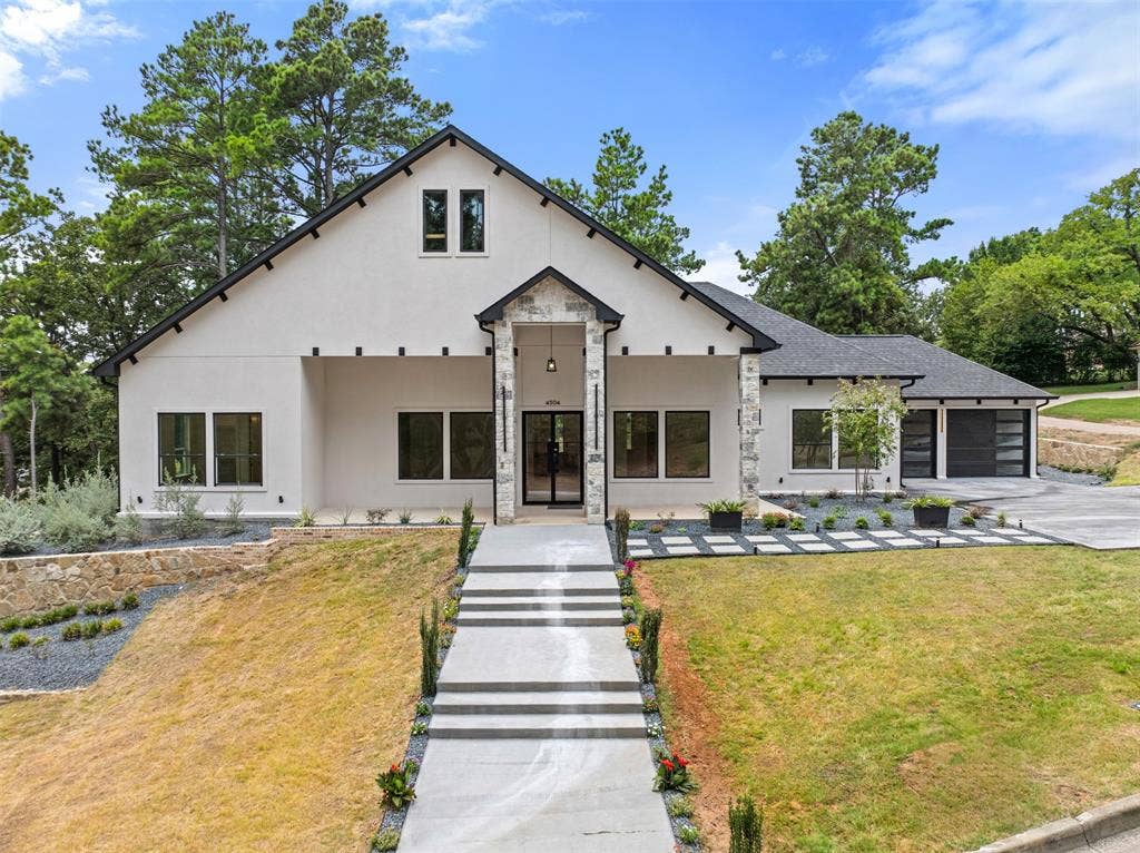 Modern farmhouse exterior with stucco finish and stone accents