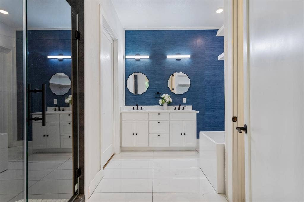 Dual vanity with white cabinetry, rectangular under-mount sinks, and matte black fixtures