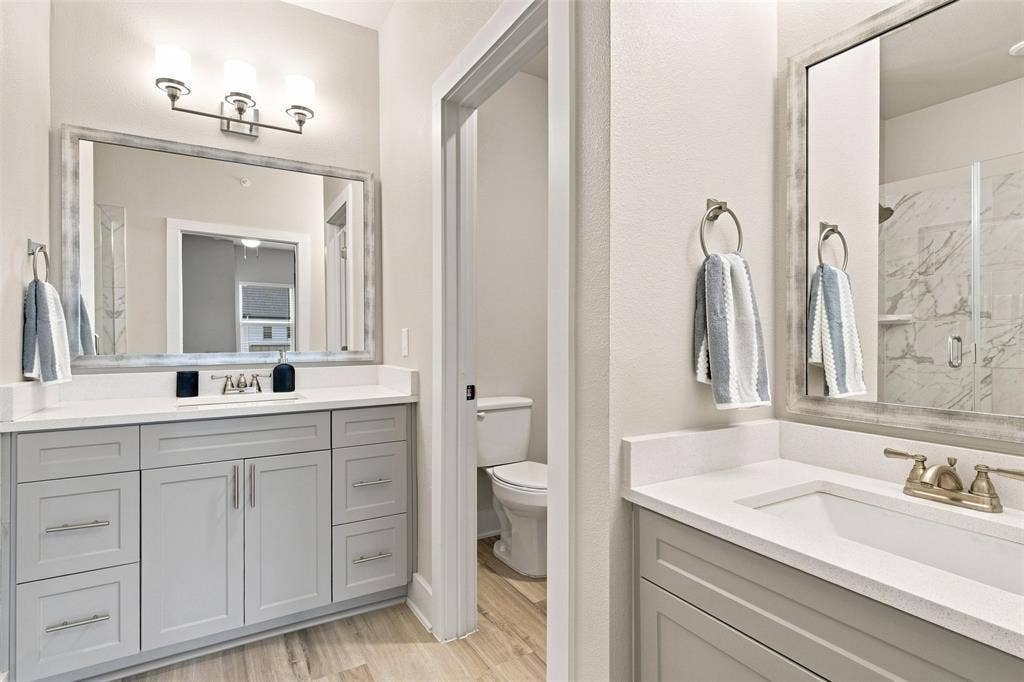 3352 Norris Street, Plano, TX 75074 Dual vanity with light gray shaker cabinetry, white countertops, and undermount sinks