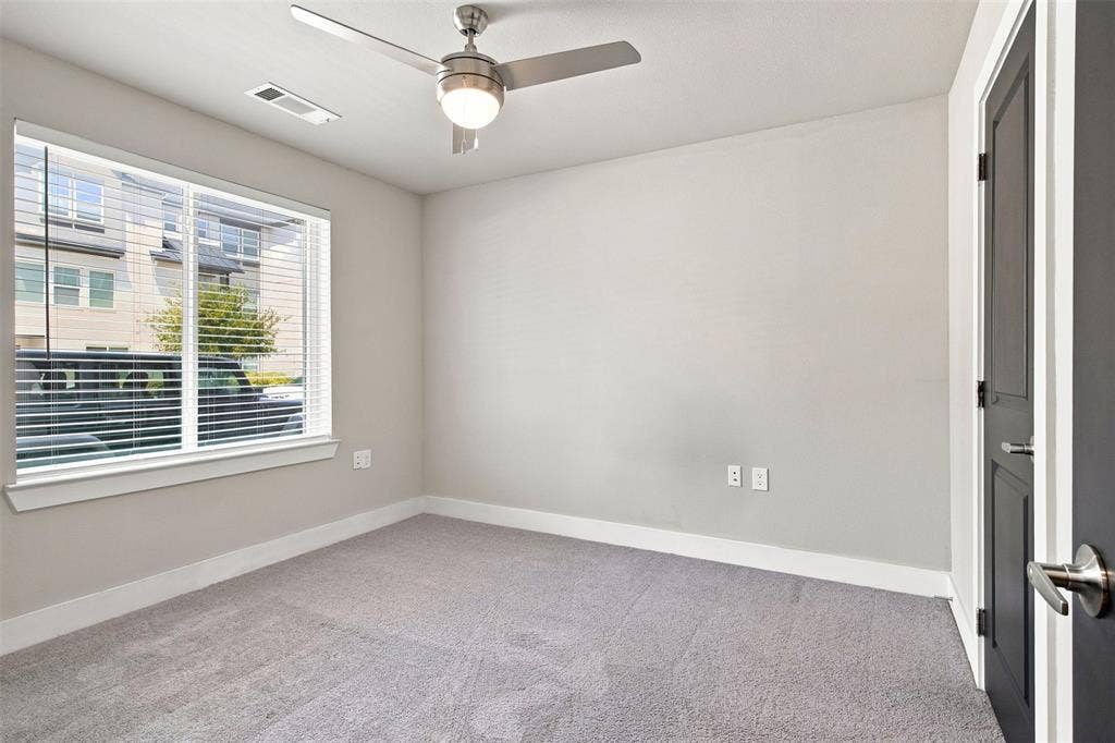 3352 Norris Street, Plano, TX 75074 Carpeted room featuring a ceiling fan with integrated lighting, a dark-paneled door with brushed nickel hardware, and a window with horizontal blinds