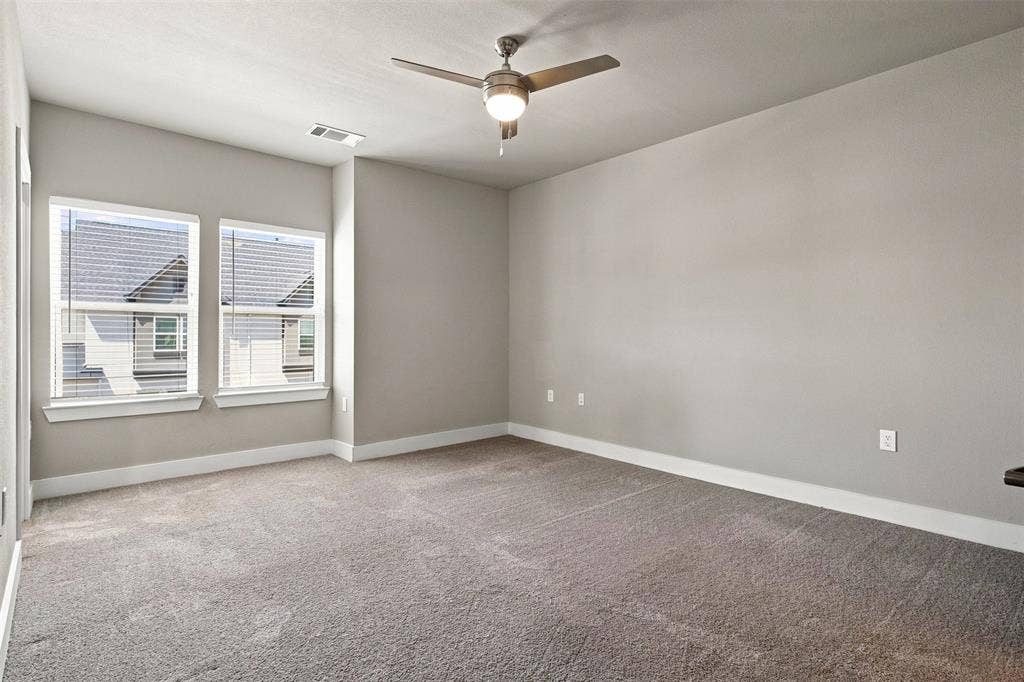 3352 Norris Street, Plano, TX 75074 Plush carpet flooring, neutral painted walls, two windows with blinds, and a ceiling fan with integrated lighting