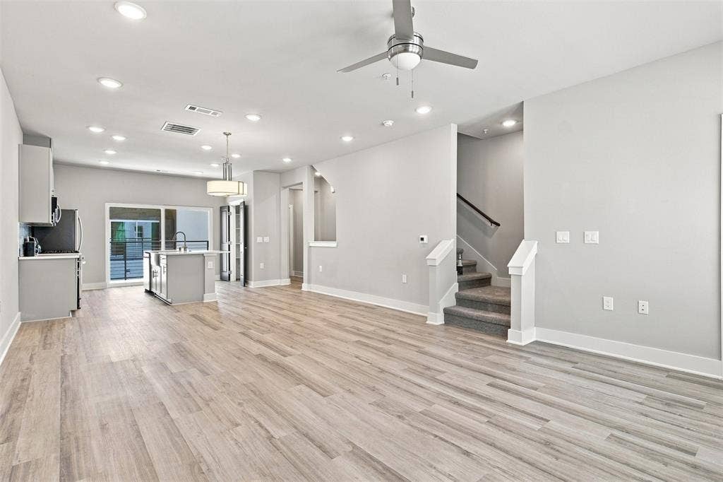 3352 Norris Street, Plano, TX 75074 Open-concept living space featuring wood-finish flooring, recessed lighting, and a modern ceiling fan