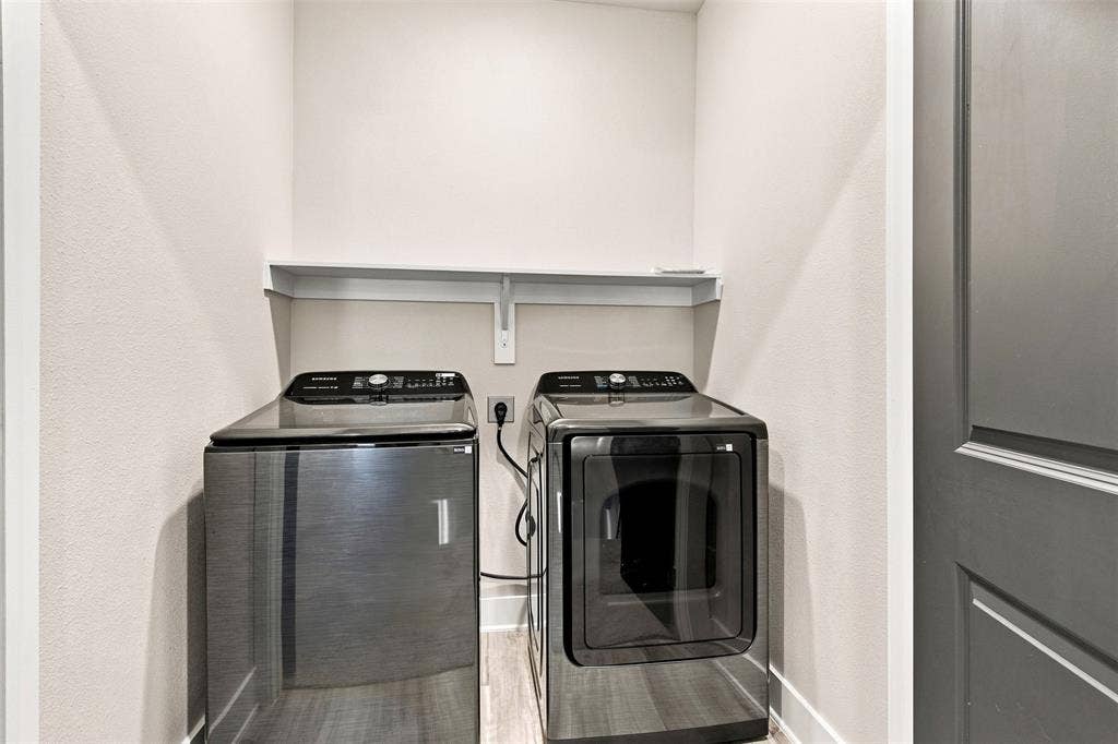 3352 Norris Street, Plano, TX 75074 Laundry area with a white wall shelf, showcasing a washer and dryer