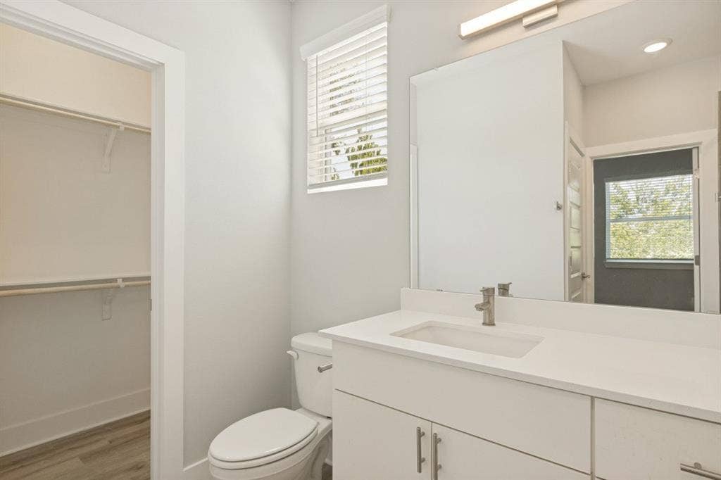 1042 Rosemont Street, #1, Austin, TX 78723 White vanity with integrated rectangular sink, single-handle faucet, and overhead bar light