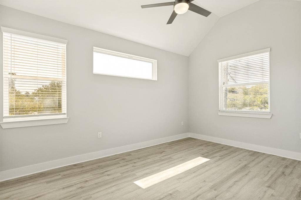 1042 Rosemont Street, #1, Austin, TX 78723 Wood-finish flooring, vaulted ceiling, and ceiling fan with integrated lighting