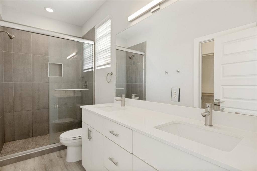 1042 Rosemont Street, #1, Austin, TX 78723 Dual vanity with integrated sinks, quartz countertop, and brushed nickel fixtures