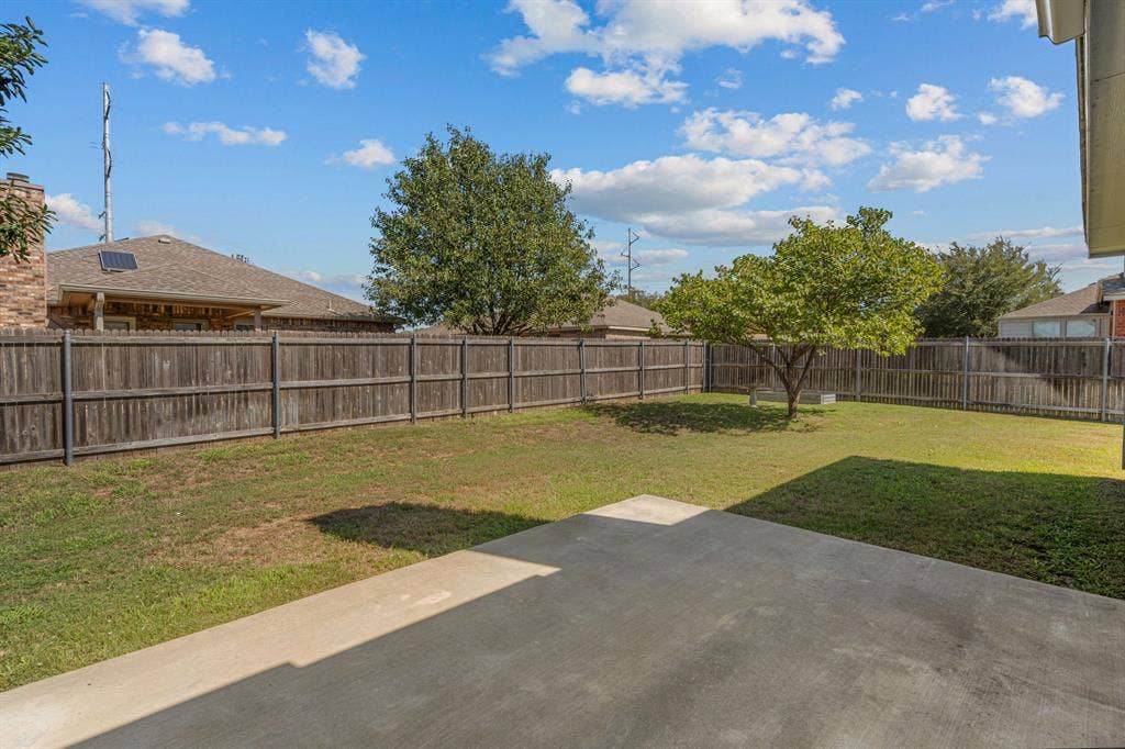 Back yard is shaded in the afternoon. Great space for a grill or play set for kids!