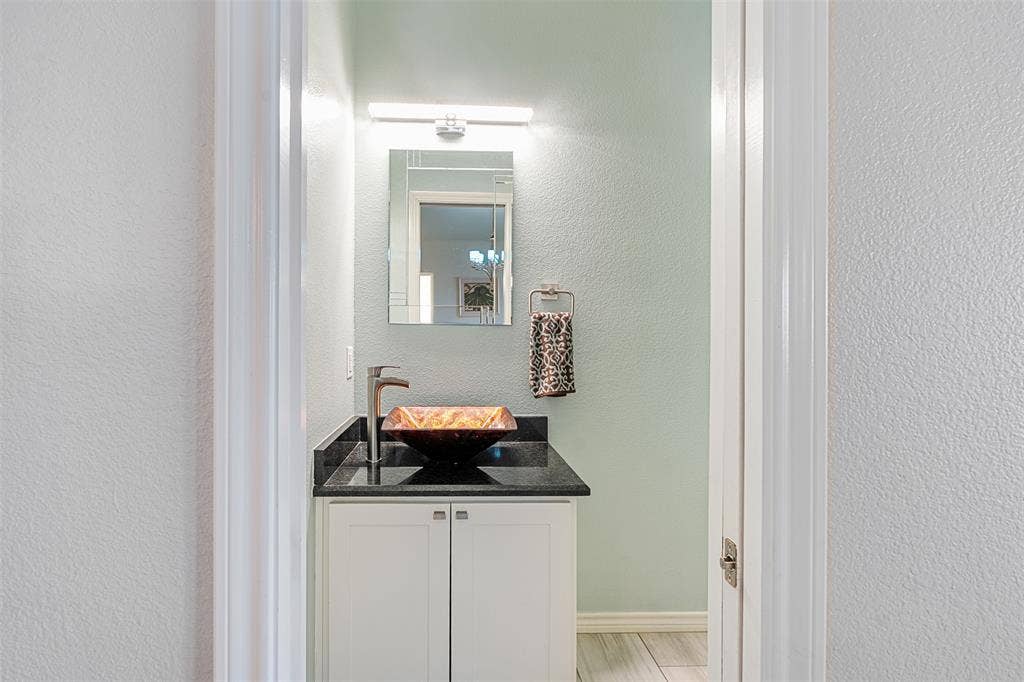 109 Briarwood Drive, Gun Barrel City, TX 75156 1/2 Bath White vanity cabinet with dark countertop, sink