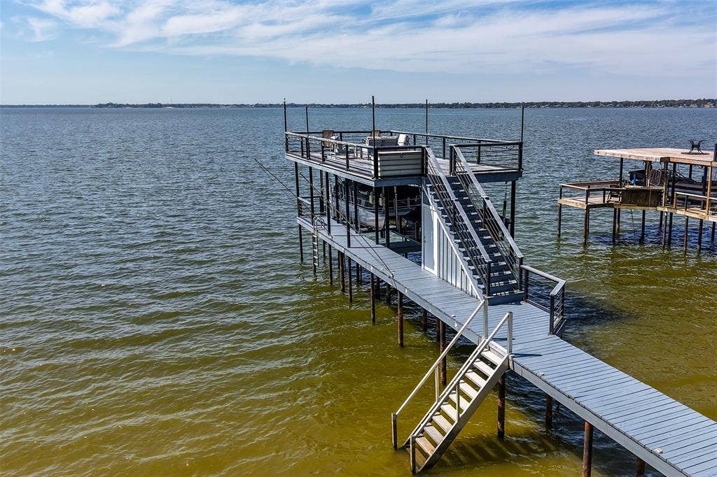 109 Briarwood Drive, Gun Barrel City, TX 75156 Two-story boat dock with a top-level deck, metal railings, and a multi-level stairway