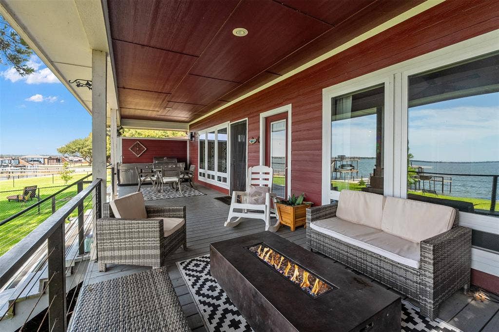 109 Briarwood Drive, Gun Barrel City, TX 75156 Expansive covered porch with a dark wood-finish ceiling and a fire table