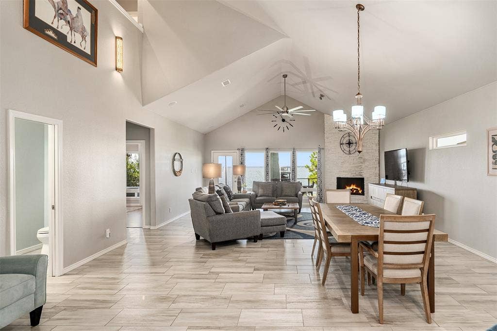 109 Briarwood Drive, Gun Barrel City, TX 75156 Vaulted ceiling recessed lighting, tile flooring, stone-clad fireplace, and chandelier lighting