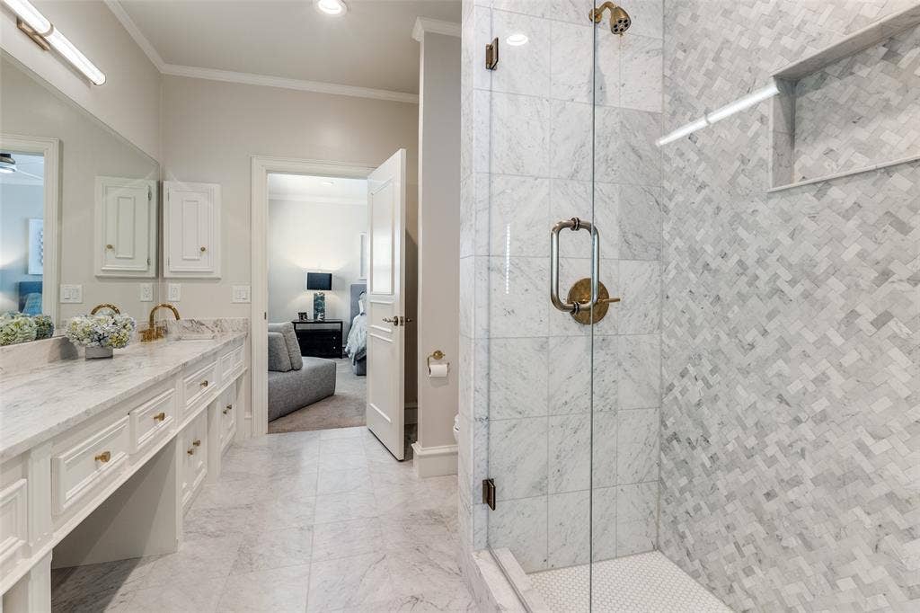 17316 Club Hill Lane, Dallas, TX 75248 Secondary jack-n-jill bathroom with leathered marble countertops, marble floors, toto toilet, and visual comfort decorative lighting.