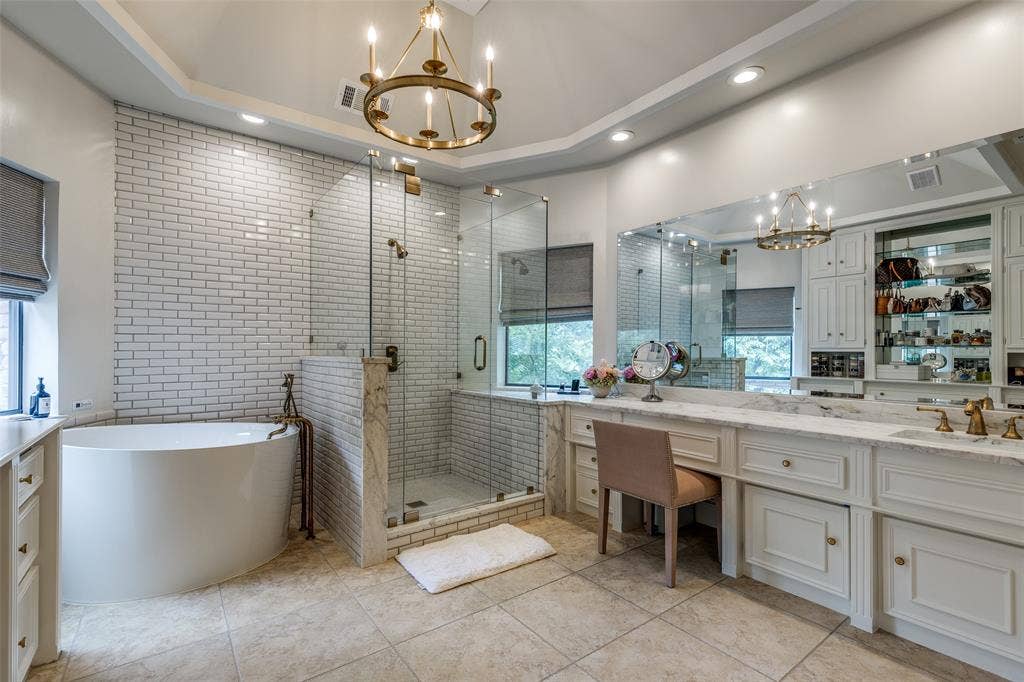 17316 Club Hill Lane, Dallas, TX 75248 Beautifully remodeled en suite bathroom with leathered marble countertops, antique brass plumbing fixtures, decorative lighting, soaking air jet bath, and a toto toilet w bidet attachment. This leads into a private toilet room and also large walk in closet.