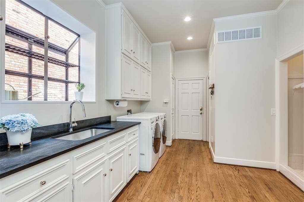 17316 Club Hill Lane, Dallas, TX 75248 Spacious laundry room between garage entry and kitchen offer full size W/D, sink storage, drip dry area, half bath, and elevator to the second level