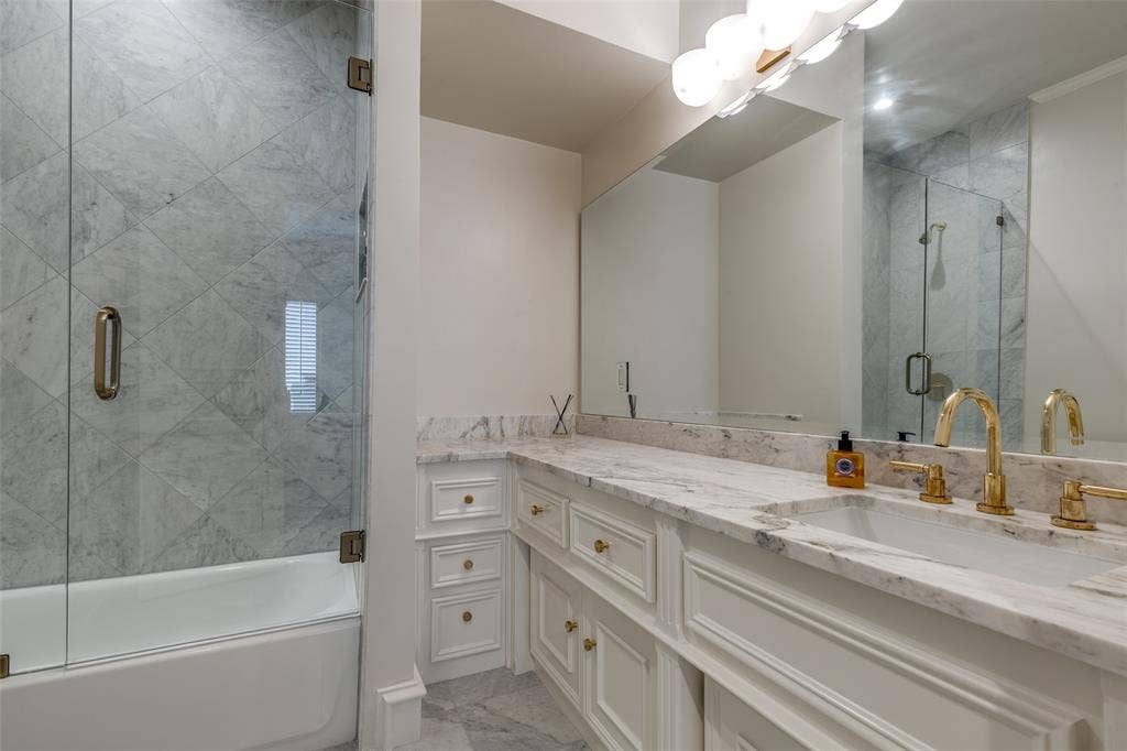 17316 Club Hill Lane, Dallas, TX 75248 En-suite bathroom for Bedroom 4 with marble tops and shower tiles, along with new plumbing fixtures.