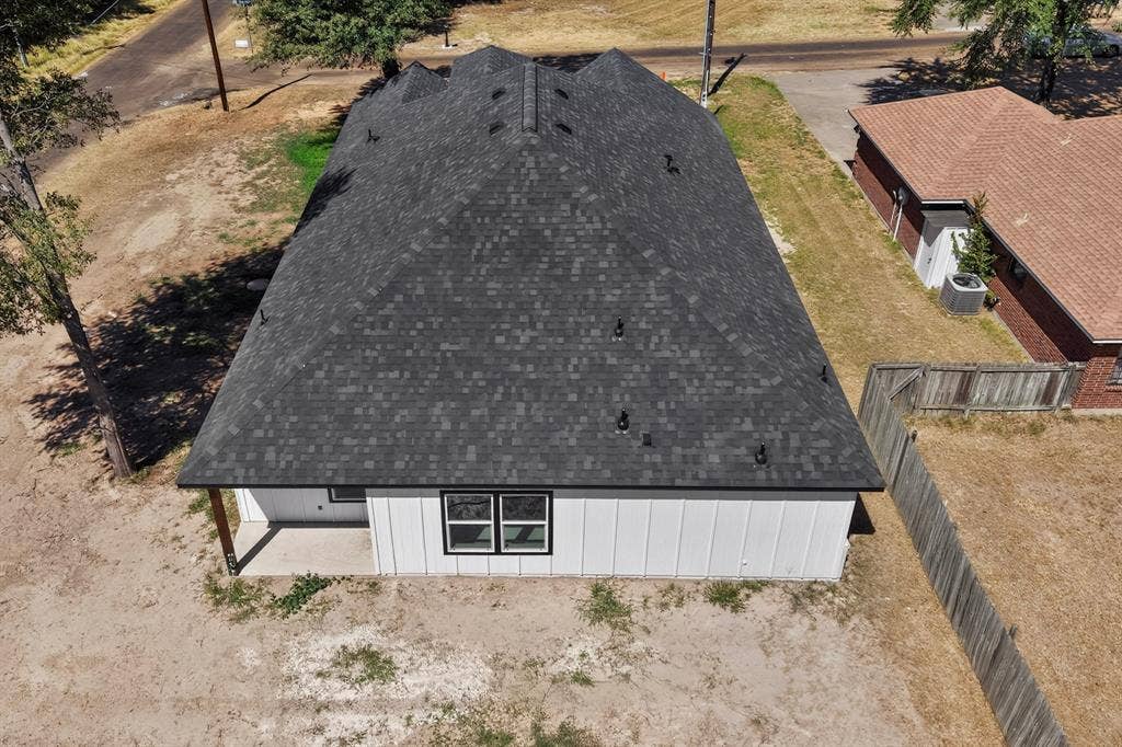 102 Redondo Drive, Gun Barrel City, TX 75156 Pitched shingle roof, white vertical siding, and black-framed windows
