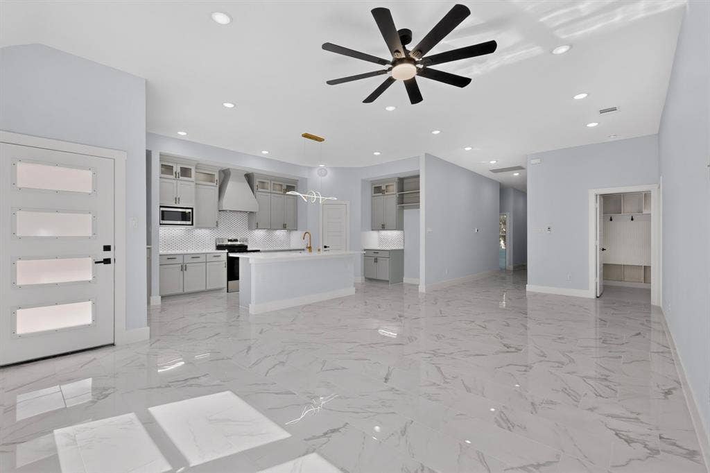 102 Redondo Drive, Gun Barrel City, TX 75156 Spacious open-concept living area featuring large format tile flooring, recessed lighting, and a contemporary ceiling fan