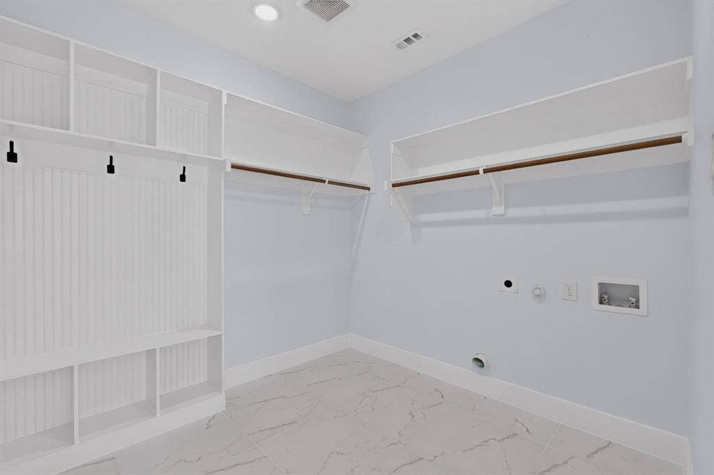 102 Redondo Drive, Gun Barrel City, TX 75156 Utility room featuring built-in shelving, hanging rods, and tile flooring