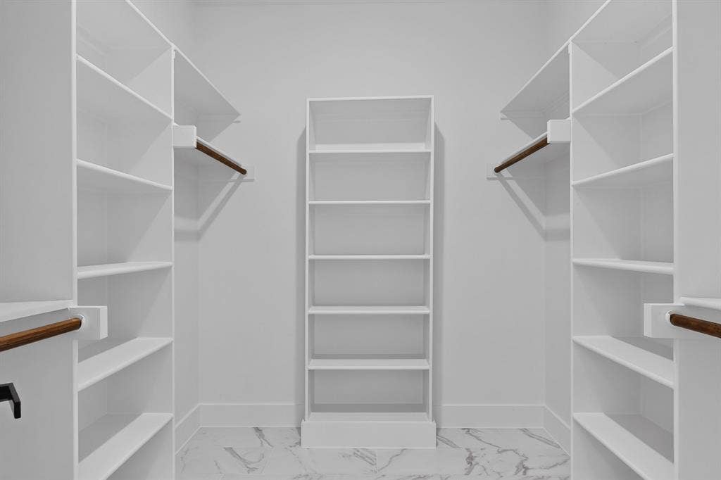 102 Redondo Drive, Gun Barrel City, TX 75156 Custom closet system featuring extensive shelving, central built-in storage, and integrated hanging rods