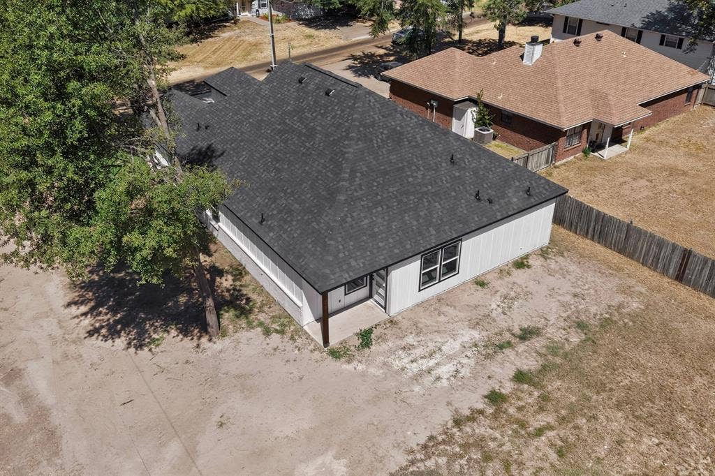 102 Redondo Drive, Gun Barrel City, TX 75156 Newly constructed residence featuring a dark shingle roof, white vertical siding, and a rear patio