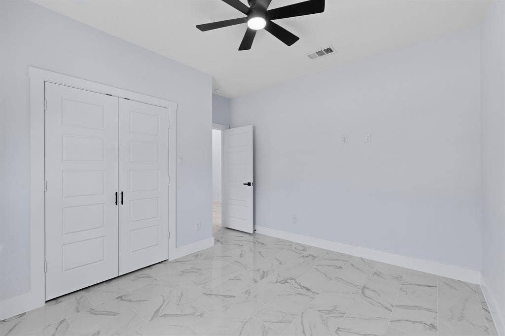 102 Redondo Drive, Gun Barrel City, TX 75156 White walls with sleek white trim, a black ceiling fan, and white doors with matte black hardware