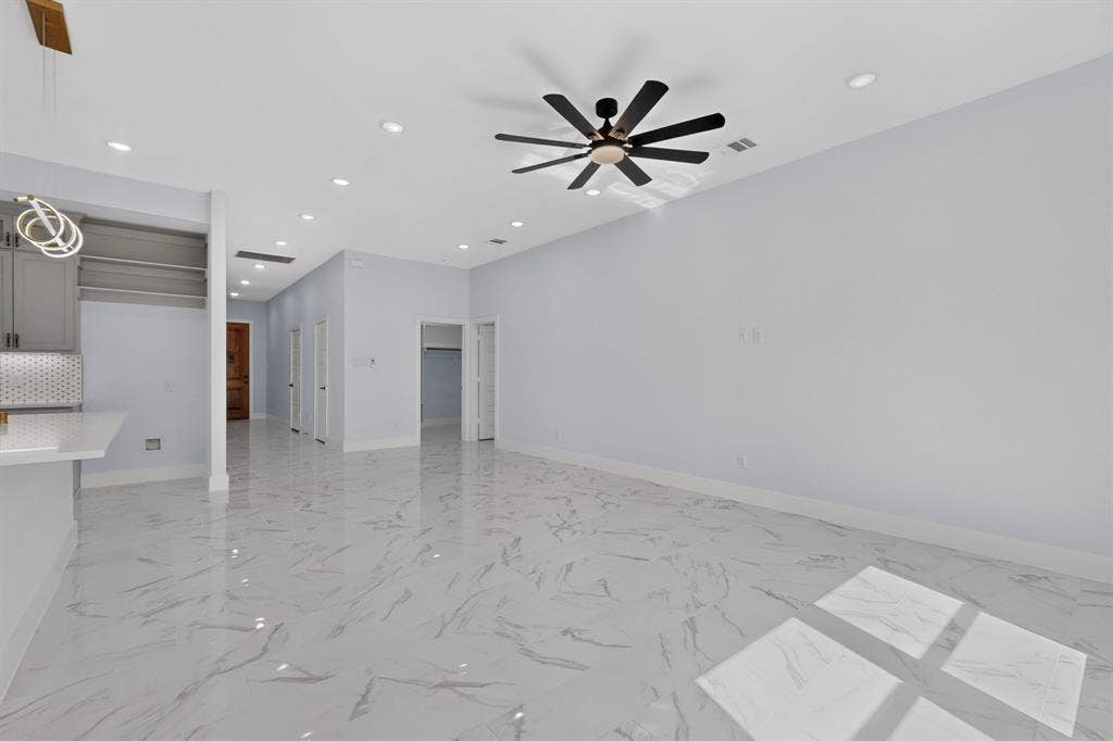 102 Redondo Drive, Gun Barrel City, TX 75156 Spacious room with large format tile flooring, recessed lighting, and a contemporary ceiling fan