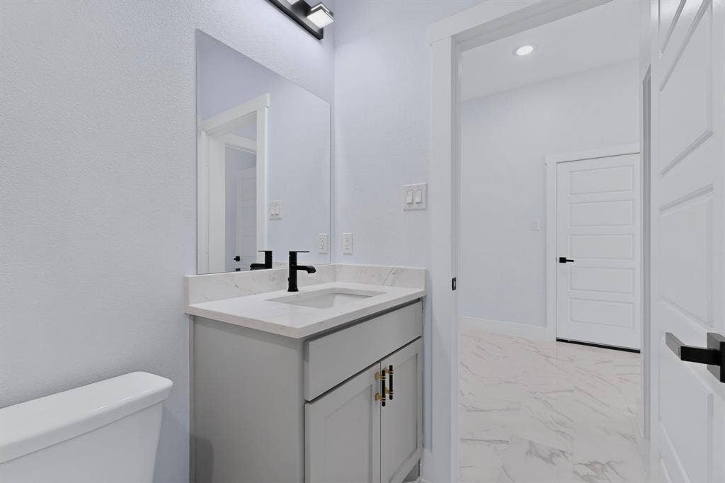 102 Redondo Drive, Gun Barrel City, TX 75156 Bathroom featuring a modern vanity with light gray cabinetry, white countertop, and matte black faucet