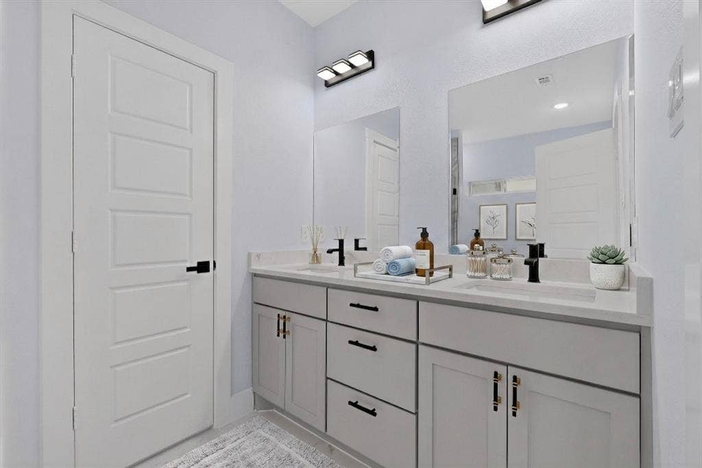 102 Redondo Drive, Gun Barrel City, TX 75156 Dual vanity with light gray cabinetry, matte black hardware, and two integrated rectangular sinks