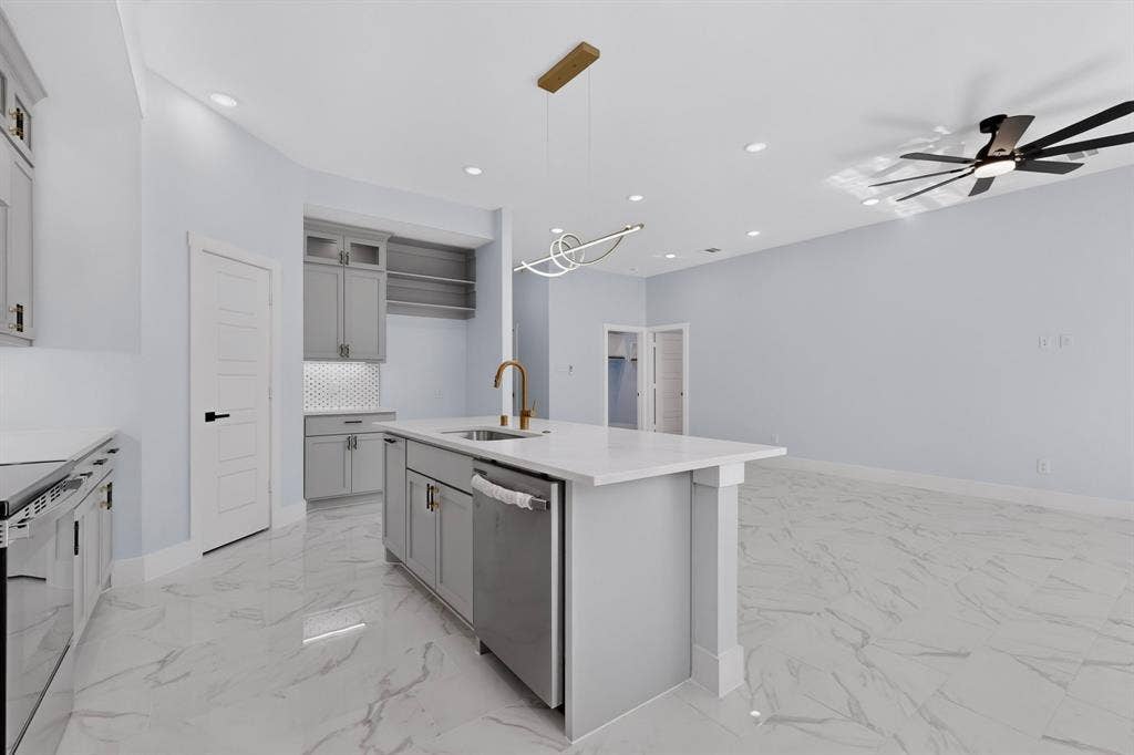 102 Redondo Drive, Gun Barrel City, TX 75156 Kitchen featuring a center island with sink, stainless steel dishwasher, white countertops, and gray cabinetry