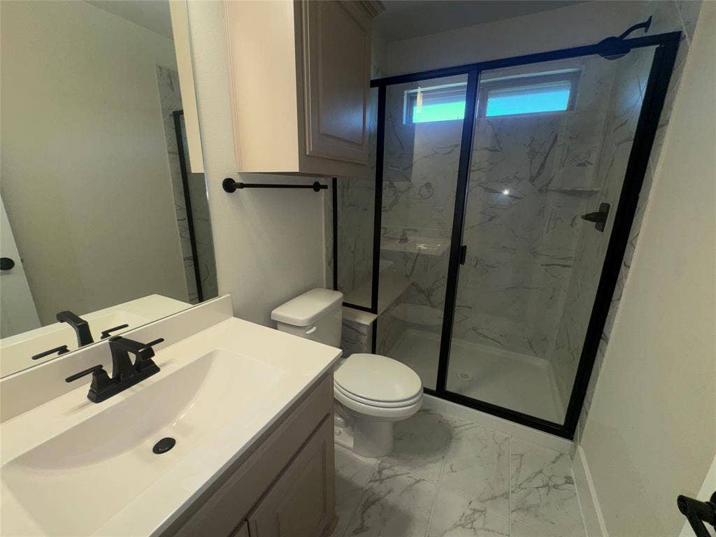 1701 Shamrock Green, Mesquite, TX 75181 Walk-in shower with black-framed glass enclosure