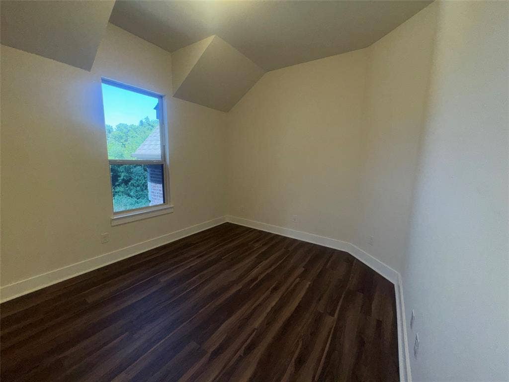 1701 Shamrock Green, Mesquite, TX 75181 Light-filled room featuring sloped ceilings and wood-finish flooring