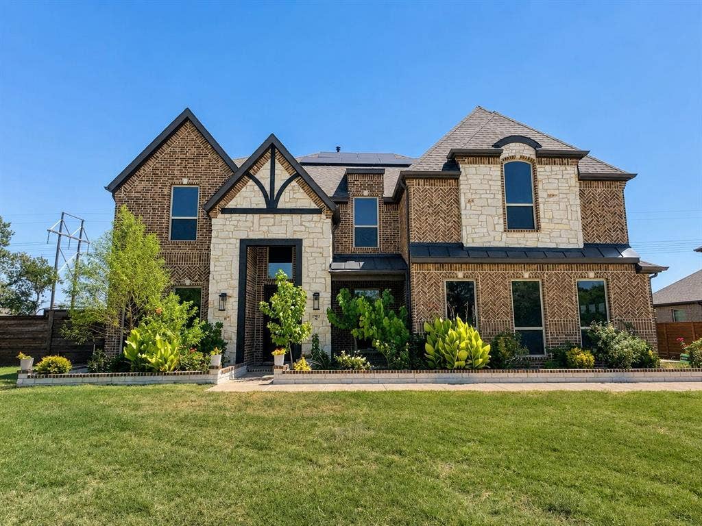 1701 Shamrock Green, Mesquite, TX 75181 Brick and stone exterior with dark trim accents, multiple gabled rooflines, and a well-maintained lawn