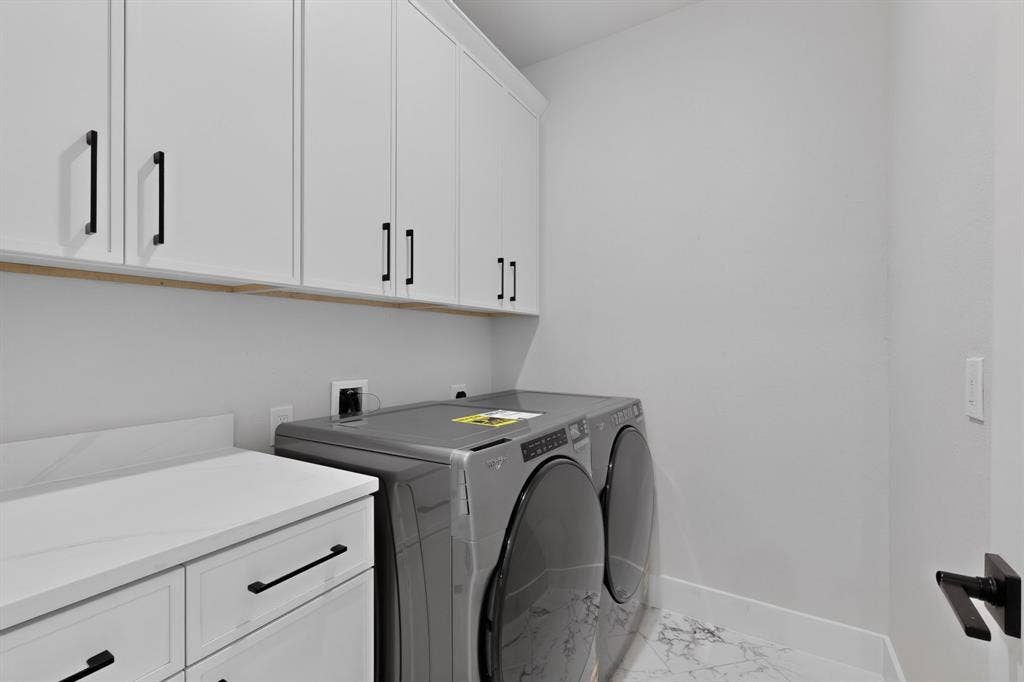 1672 Brookview Drive, Lancaster, TX 75146 White shaker-style cabinetry with black hardware, white countertop, and marble-look flooring