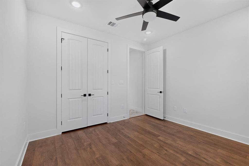 1672 Brookview Drive, Lancaster, TX 75146 Wood-finish flooring, recessed lighting, ceiling fan with light, and white paneled doors with matte black hardware
