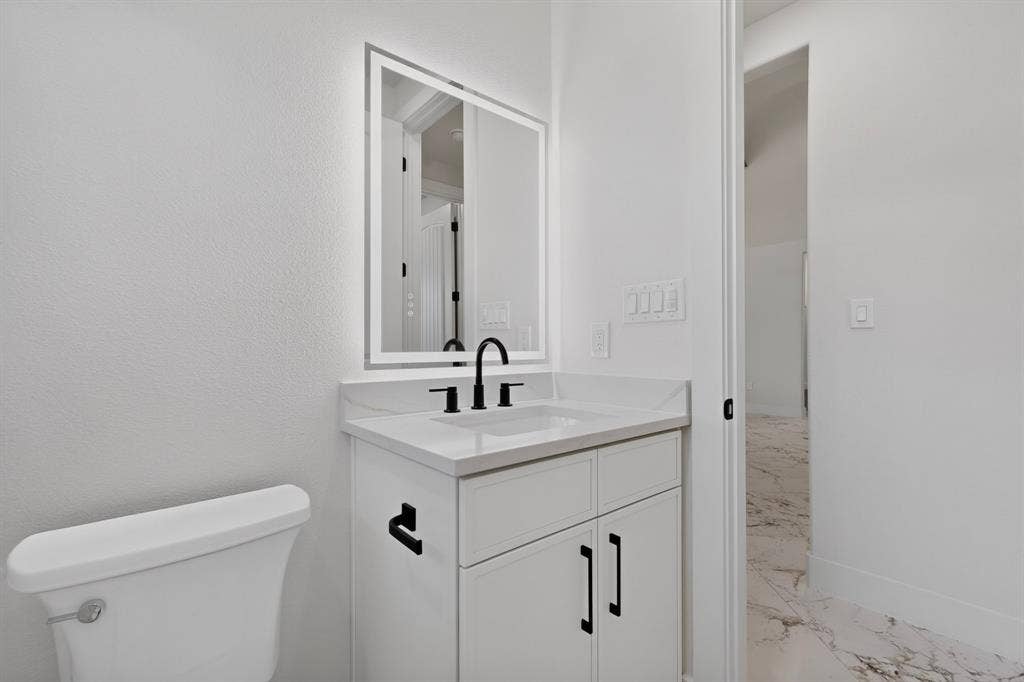 1672 Brookview Drive, Lancaster, TX 75146 White vanity with integrated rectangular sink and matte black faucet
