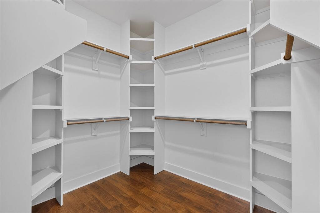 1672 Brookview Drive, Lancaster, TX 75146 Walk-in closet featuring built-in shelving, multiple hanging rods, and wood-finish flooring