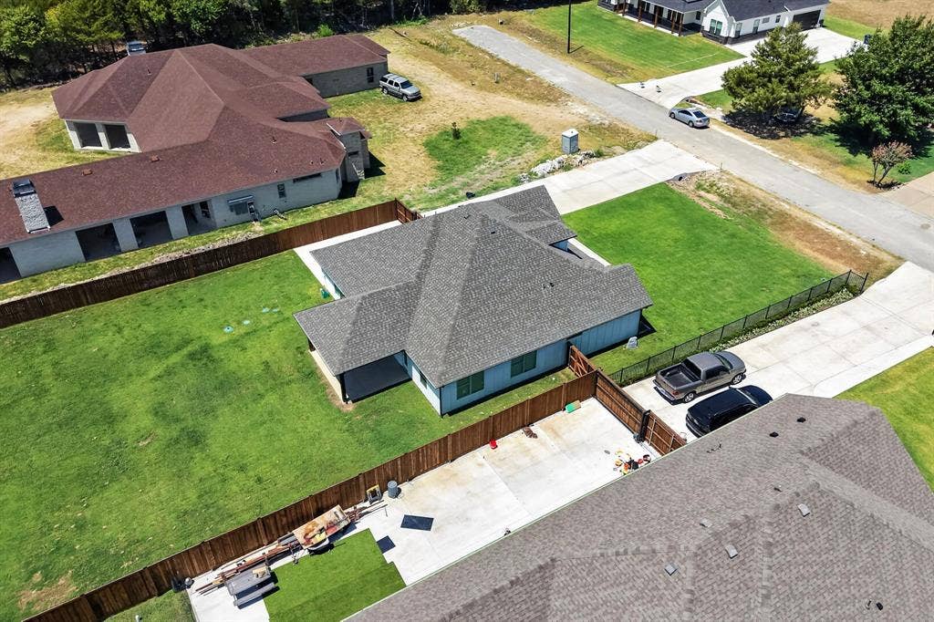 1672 Brookview Drive, Lancaster, TX 75146 Expansive lot featuring a fenced backyard, concrete driveway, and covered patio