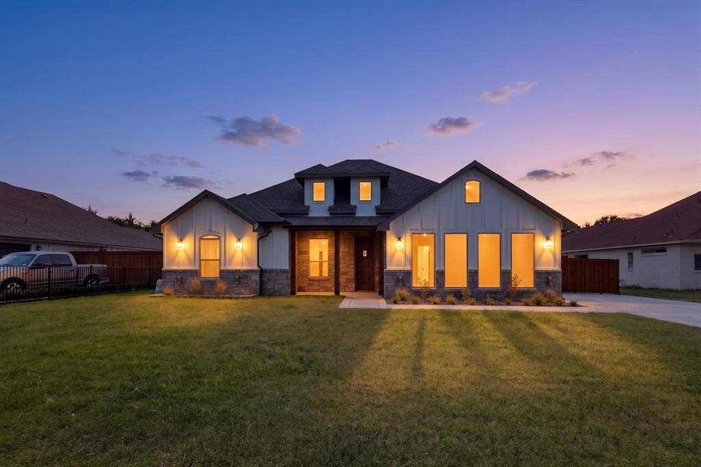 1672 Brookview Drive, Lancaster, TX 75146 home with a stone and board-and-batten facade
