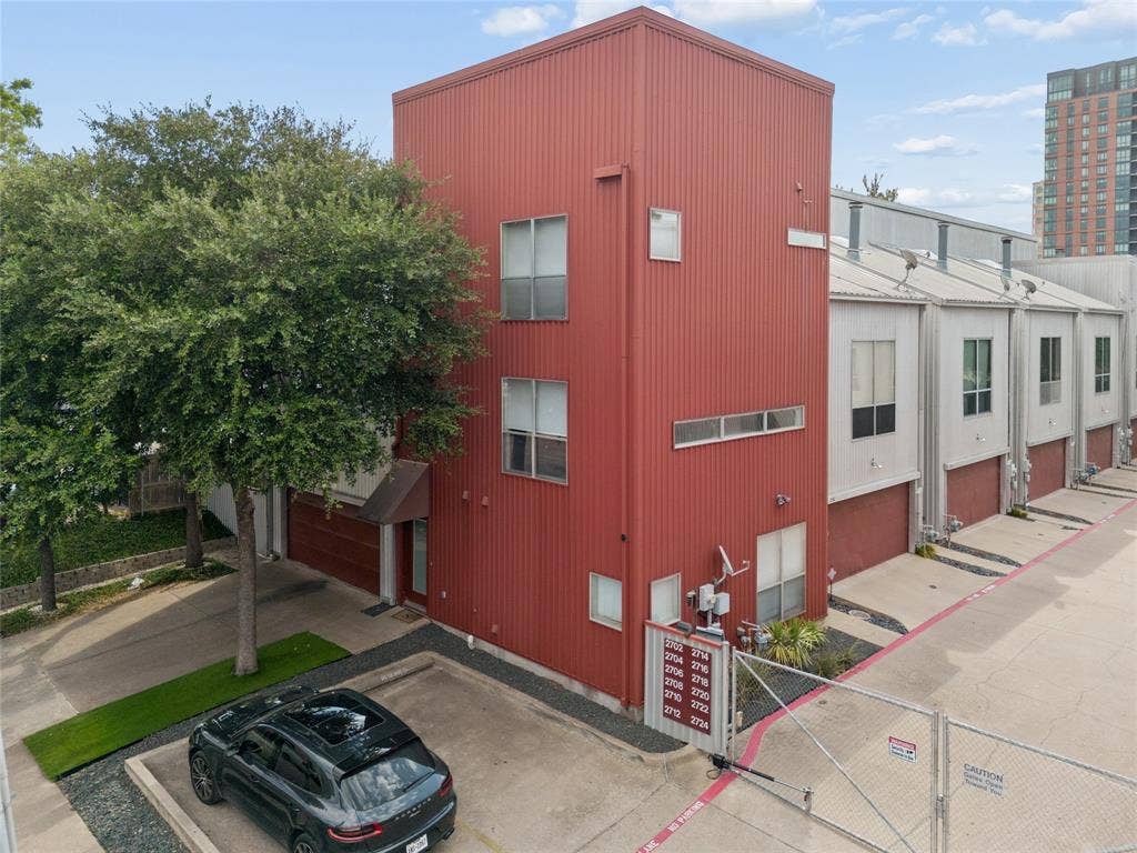 2714 Shelby Avenue, Dallas, TX 75219 Red corrugated metal siding exterior with multiple windows